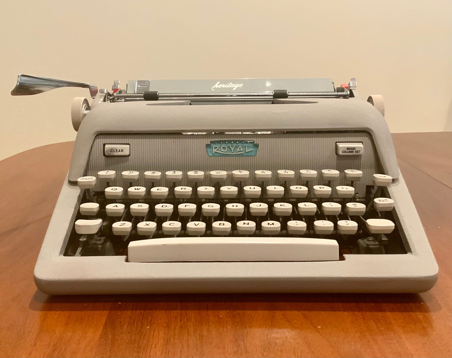 an image of a Royal typewriter sitting on a wooden table