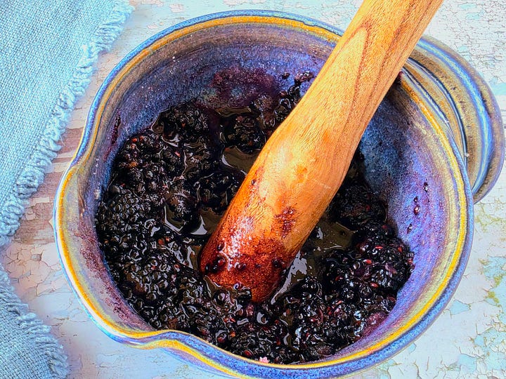 steps for making the blackberry coulis by combining, muddling, and straining blackberries, sugar, and salt