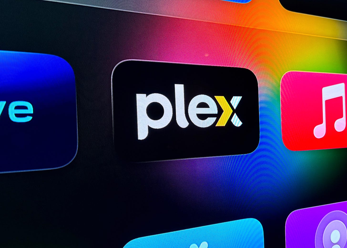 Plex icon from an Apple TV interface.