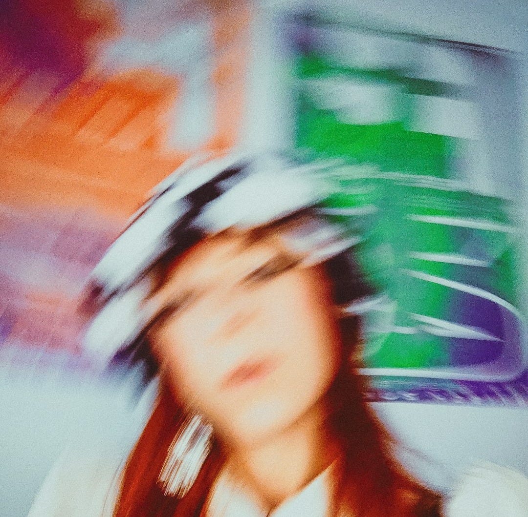 a blurry photo of a woman wearing a hat