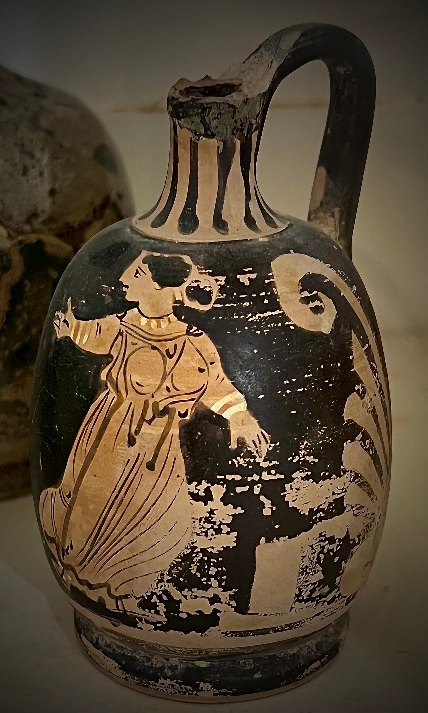 A black and white vase with a person and a bird

Description automatically generated