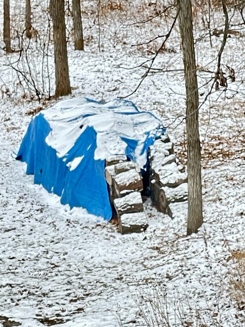 A blue tarp covered in snow

Description automatically generated