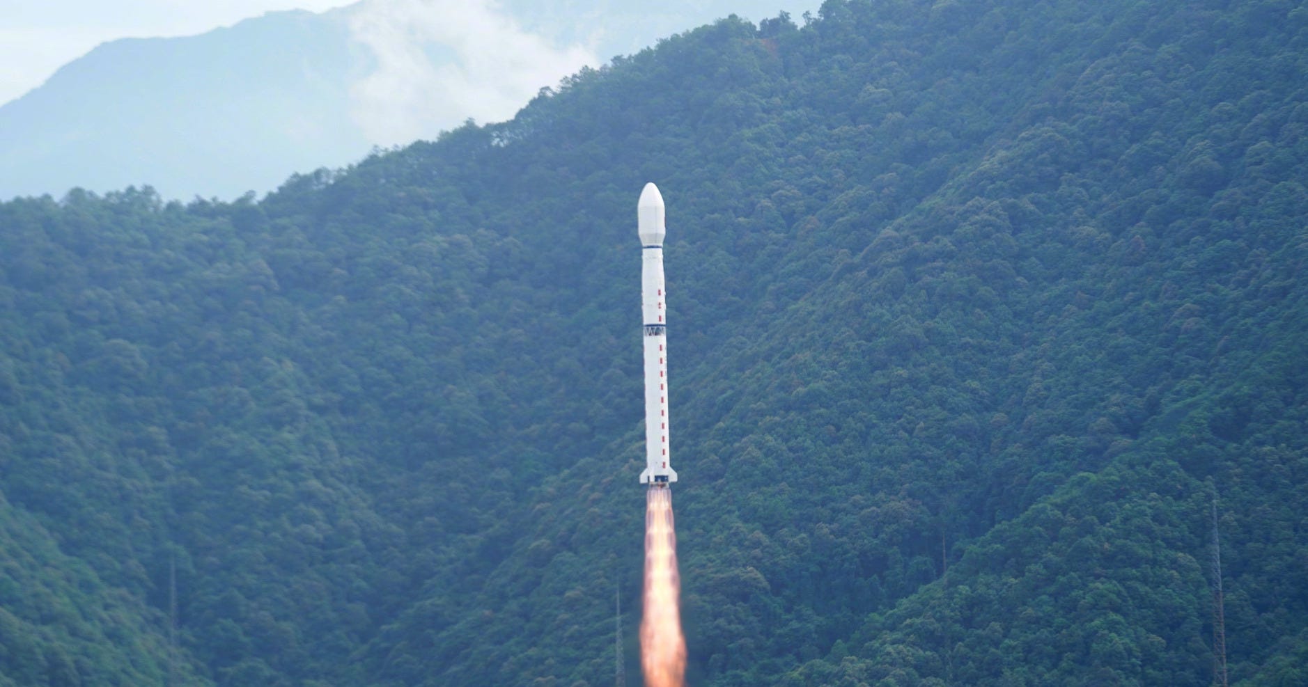 The Long March 4C Y64 vehicle during first-stage flight from the Xichang Satellite Launch Center. The Long March 4C Y64 vehicle during first-stage flight from the Xichang Satellite Launch Center.