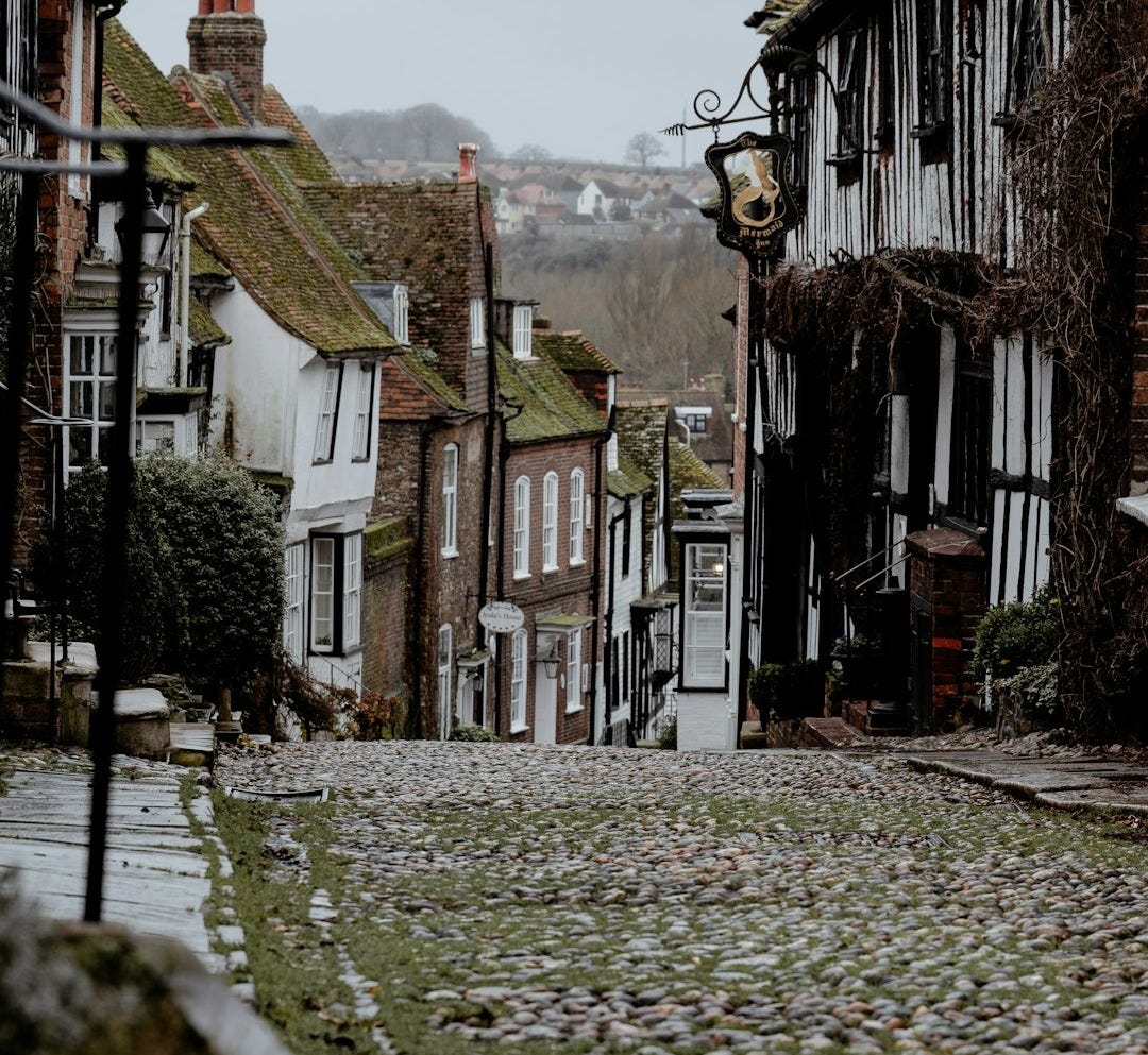 a cobblestone street in a small village a cobblestone street in a small village