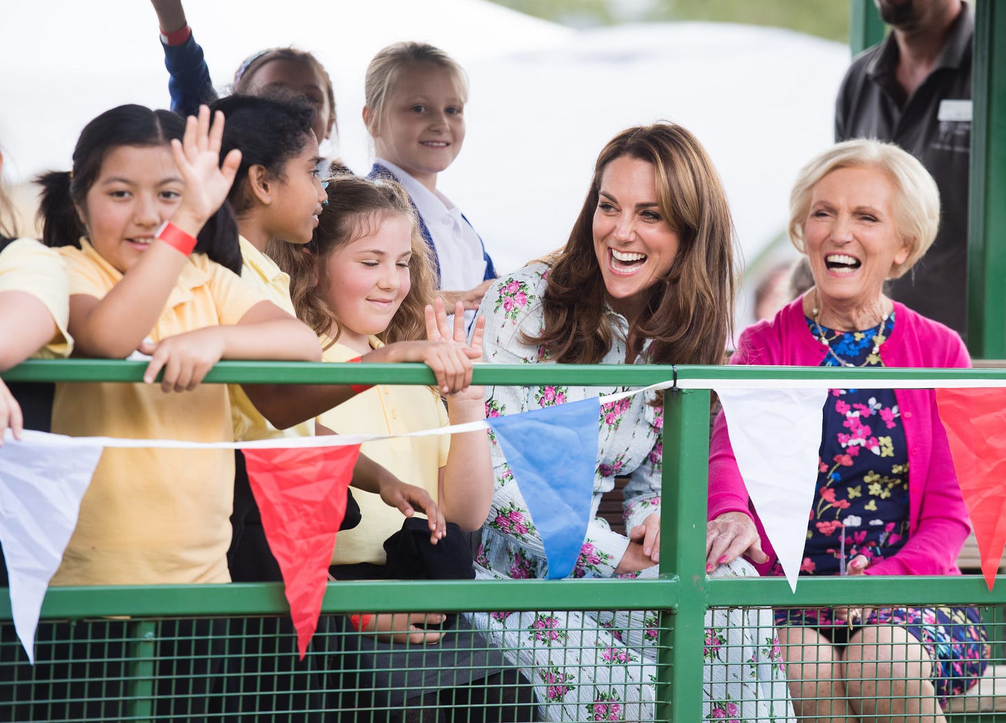 Kate Middleton and Mary Berry smiling with a group of schoolchildren