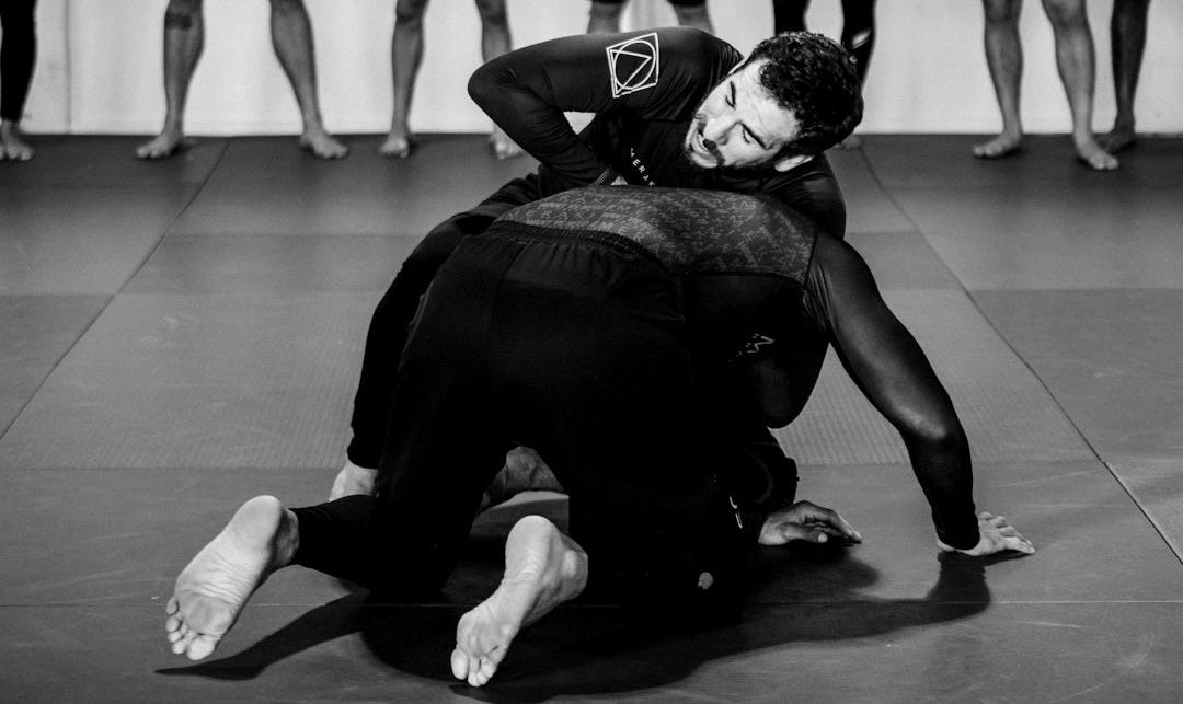group of people in black shirts and black pants doing yoga group of people in black shirts and black pants doing yoga