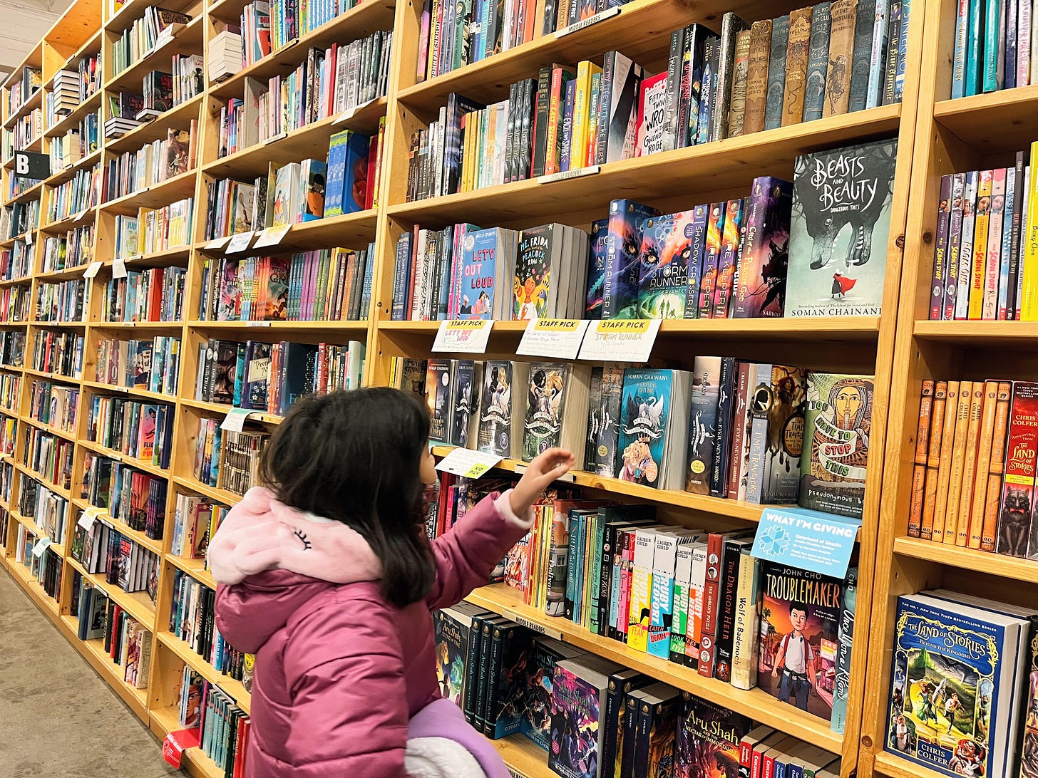 girl at long row of bookshelves