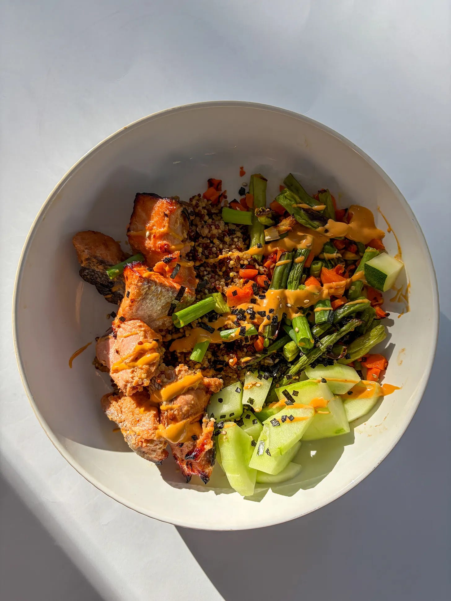 air fryer bang bang salmon bowls with salmon bites, cucumber, carrots, green beans, green onions, and tri-color quinoa all with a bright sauce air fryer bang bang salmon bowls with salmon bites, cucumber, carrots, green beans, green onions, and tri-color quinoa all with a bright sauce