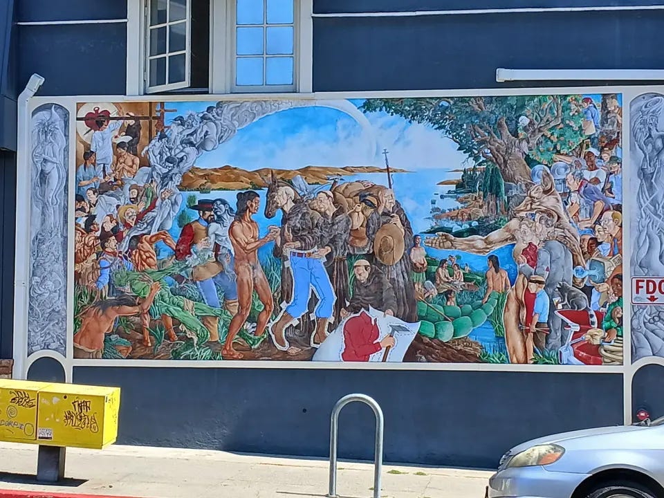 Colorful mural in Oakland depicting Ohlone people, colonizers, and scenes of historical trauma, painted on the side of a building. Colorful mural in Oakland depicting Ohlone people, colonizers, and scenes of historical trauma, painted on the side of a building.