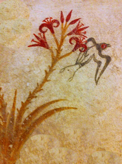 A cluster of bright red lilies in several different stages of growth - buds, partly open blooms, and fully open blooms - grows on a stalk that rises up from a plant that sports long, narrow leaves. Next to the flowers, a black-and-white swallow with a red head and a long tail flies.