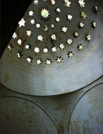 This may contain: several stars are arranged in the shape of a star on a metal surface with dark background This may contain: several stars are arranged in the shape of a star on a metal surface with dark background
