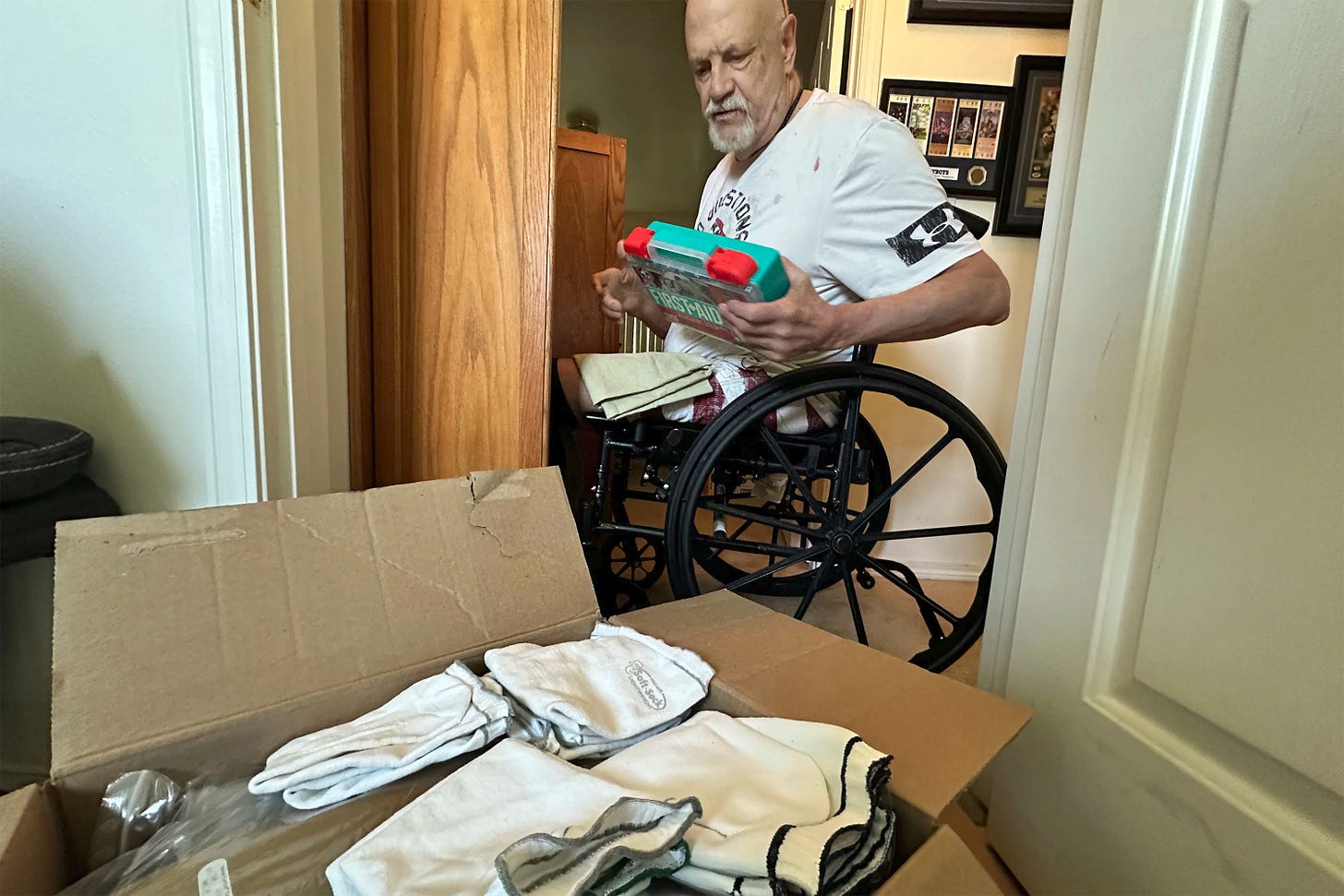A photo of Kim Hilton packing up his belongings in boxes. A photo of Kim Hilton packing up his belongings in boxes.