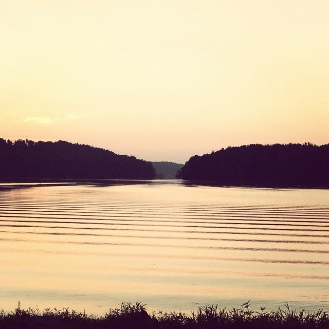 sepia toned lake at sunset with ripples on the water between two small islands