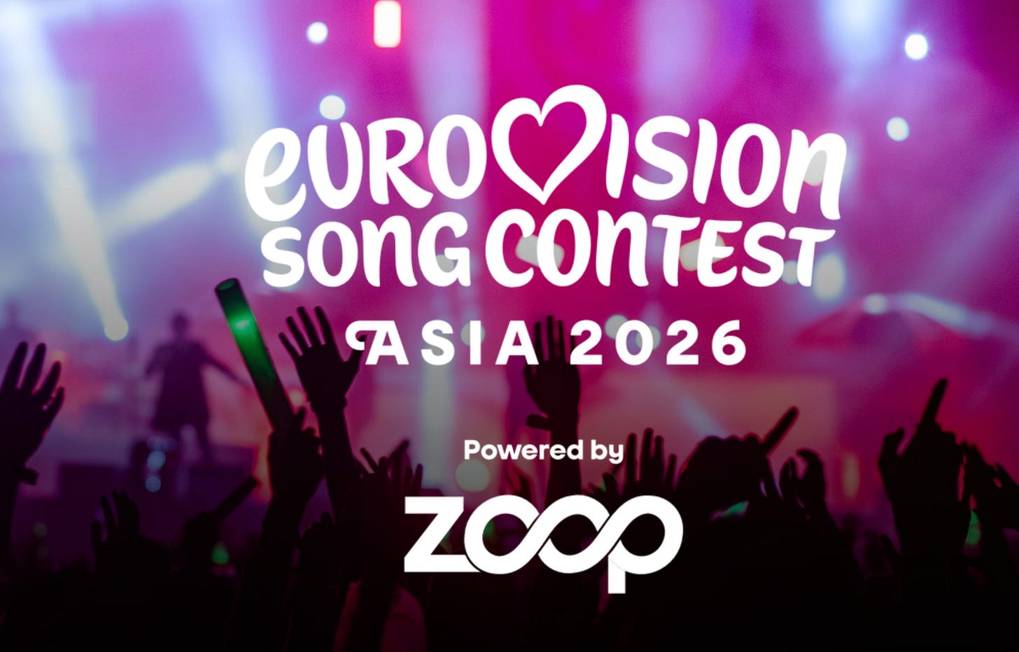 An official promotional graphic for the "Eurovision Song Contest Asia 2026" featured in the file 24ee7780-824d-4fd4-973d-eff47cc88abb_1990x1274.webp.  The image shows a vibrant, concert-like atmosphere with a crowd of silhouettes raising their hands and holding green glow sticks against a backdrop of bright, colorful stage lights in shades of pink, purple, and blue.  Superimposed in the center is the white text logo:  EUROVISION (with a heart symbol replacing the 'V')  SONG CONTEST  ASIA 2026  At the bottom, it reads "Powered by ZOOP" with the Zoop brand logo.