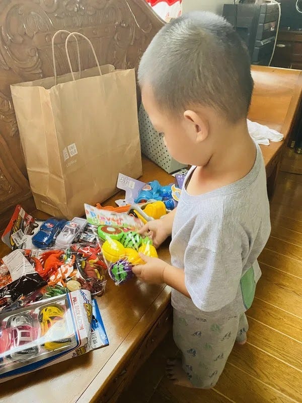 A little boy looking at his Christmas presents