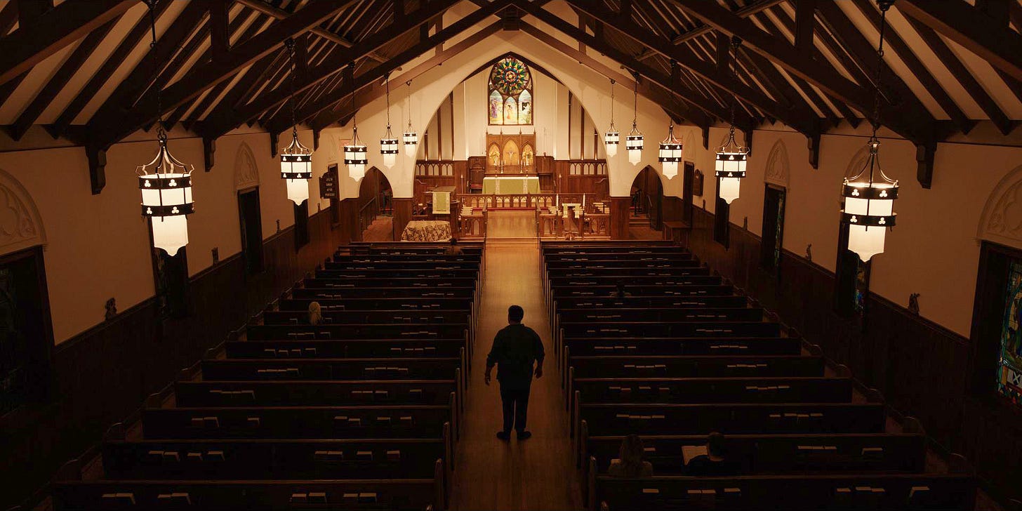 A man stands in the nave of a church A man stands in the nave of a church