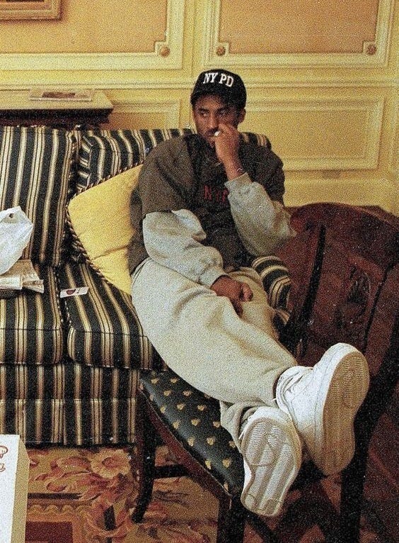 This may contain: a man sitting on top of a couch in a living room This may contain: a man sitting on top of a couch in a living room
