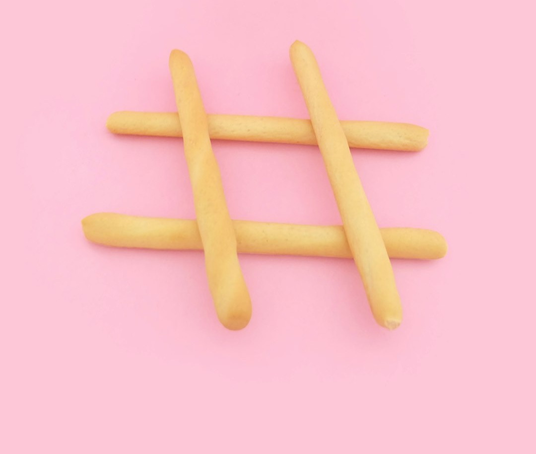 four brown wooden sticks on pink surface four brown wooden sticks on pink surface