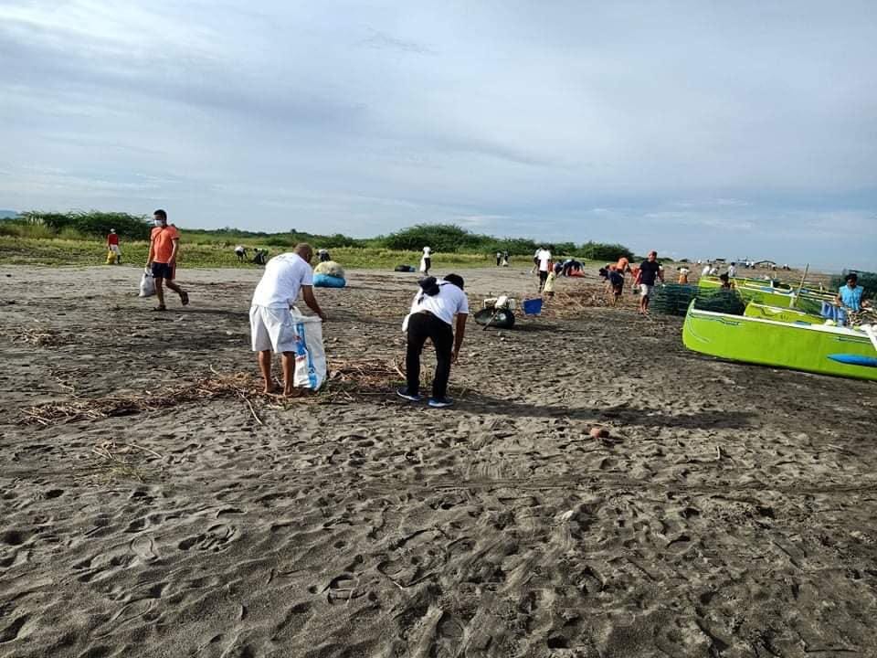 May be an image of one or more people, people standing, body of water and beach May be an image of one or more people, people standing, body of water and beach