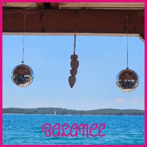 A mirror balls from a wood beam

AI-generated content may be incorrect.