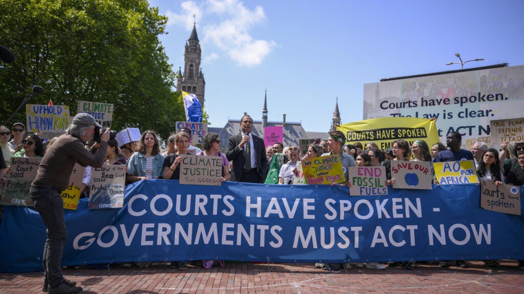 Vanuatu's Climate Change Minister Ralph Regenvanu delivers a speech as he attends a demonstration ahead of the International Court of Justice (ICJ) session tasked with issuing the first Advisory Opinion on States' legal obligations to address climate change, in The Hague, on 23 July 2025.