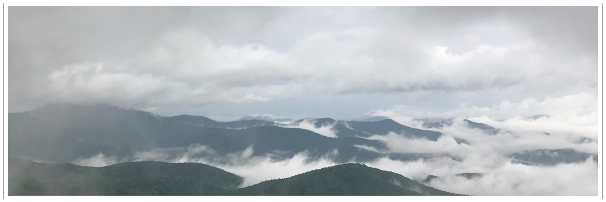 dense morning fog in valleys between rolling mountain ridges