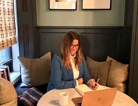 Gallery of Laurie Wetzel working at her desk, on the subway, and speaking at a conference