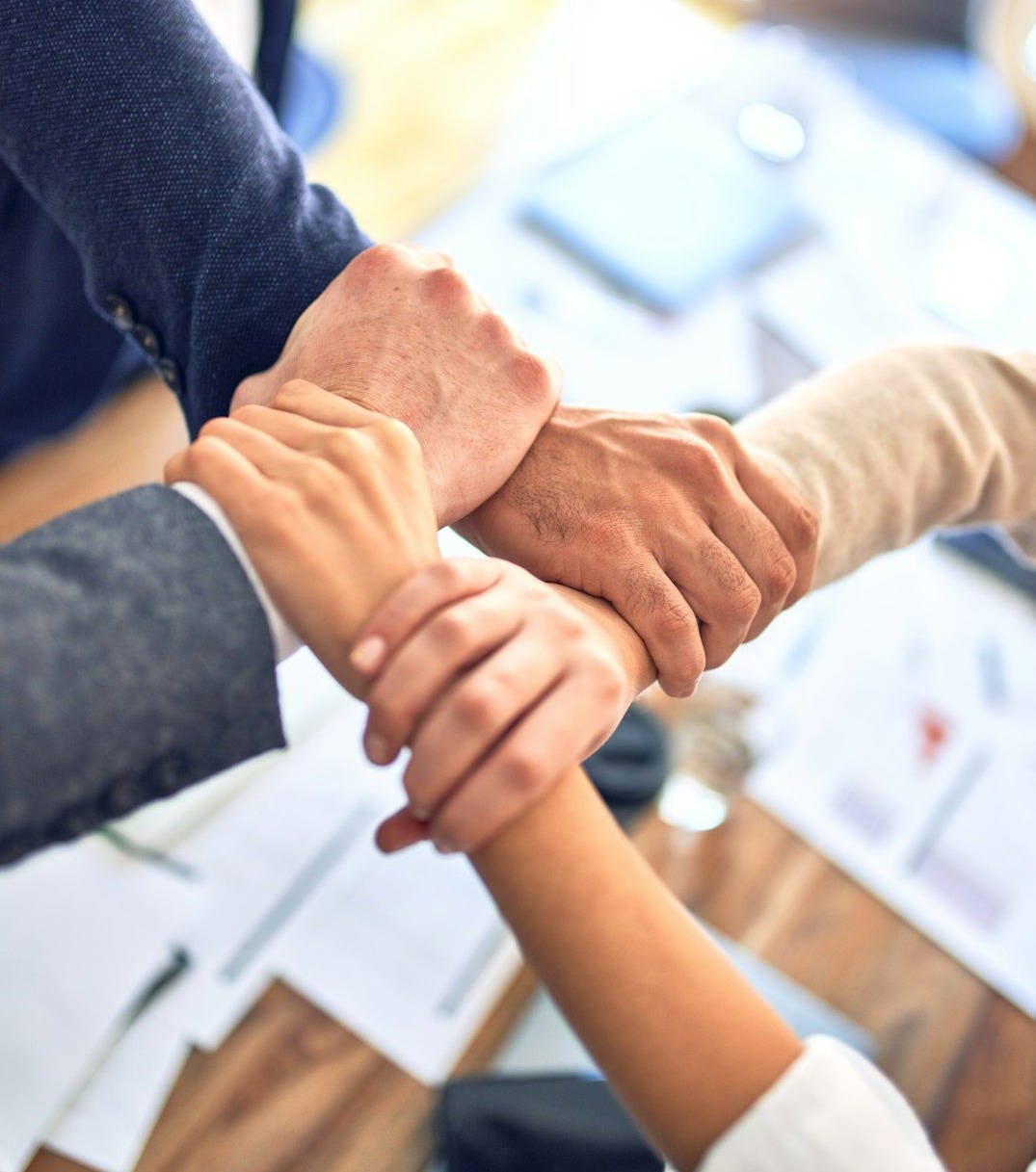 person in black long sleeve shirt holding persons hand