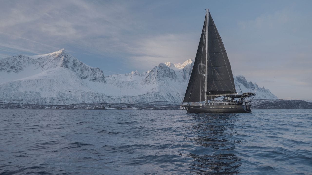 Participants sail through the Norwegian fjords during a Ski & Sail adventure, using a liveaboard boat to access remote ski terrain. Participants sail through the Norwegian fjords during a Ski & Sail adventure, using a liveaboard boat to access remote ski terrain.