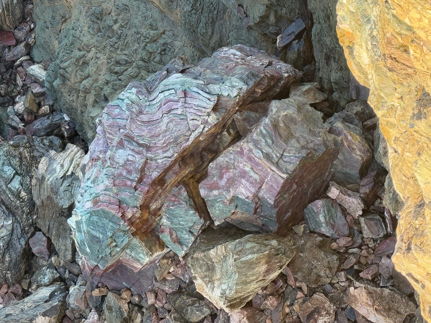 a large boulder of jade on the beach