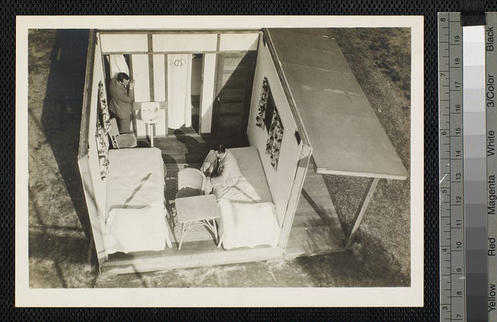 One shows a foundation with completed cabins in the background, another shows a frame without a roof, and no furniture. The third image is a completed house with porch viewed from the front, and the last is a furnished cabin with no roof to show the interior layout