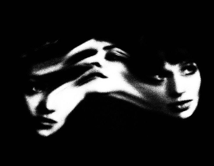 This may contain: black and white photograph of two women with their hands on their face
