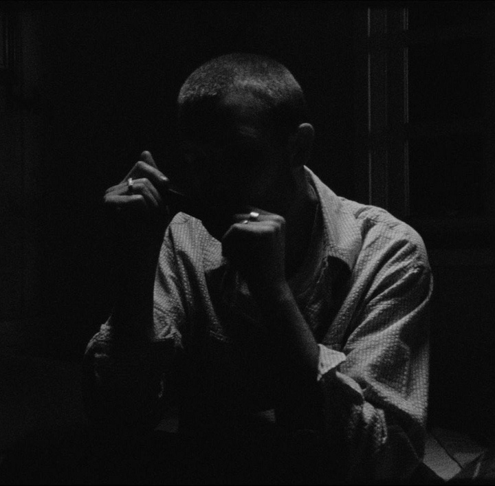 Asa Tata Asa Fiu album cover and a low lit Kit Gordon.