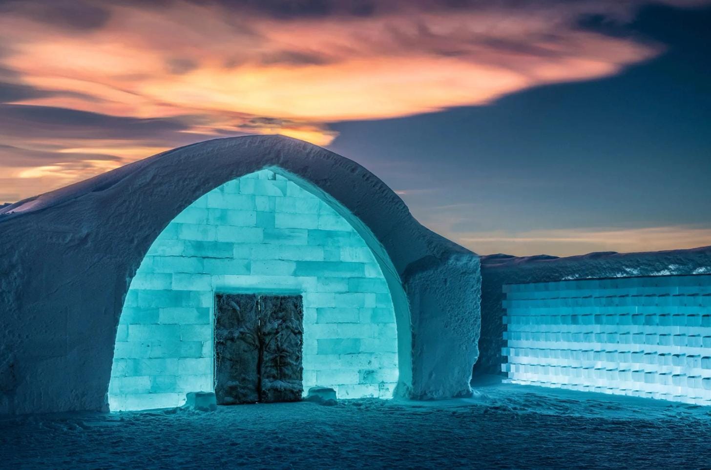 Exterior of ICEHOTEL in Swedish Lapland surrounded by snow and ice.