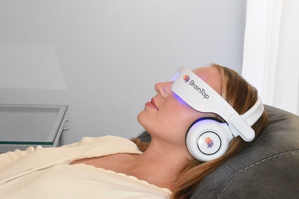 woman lying down wearing a BrainTap headset