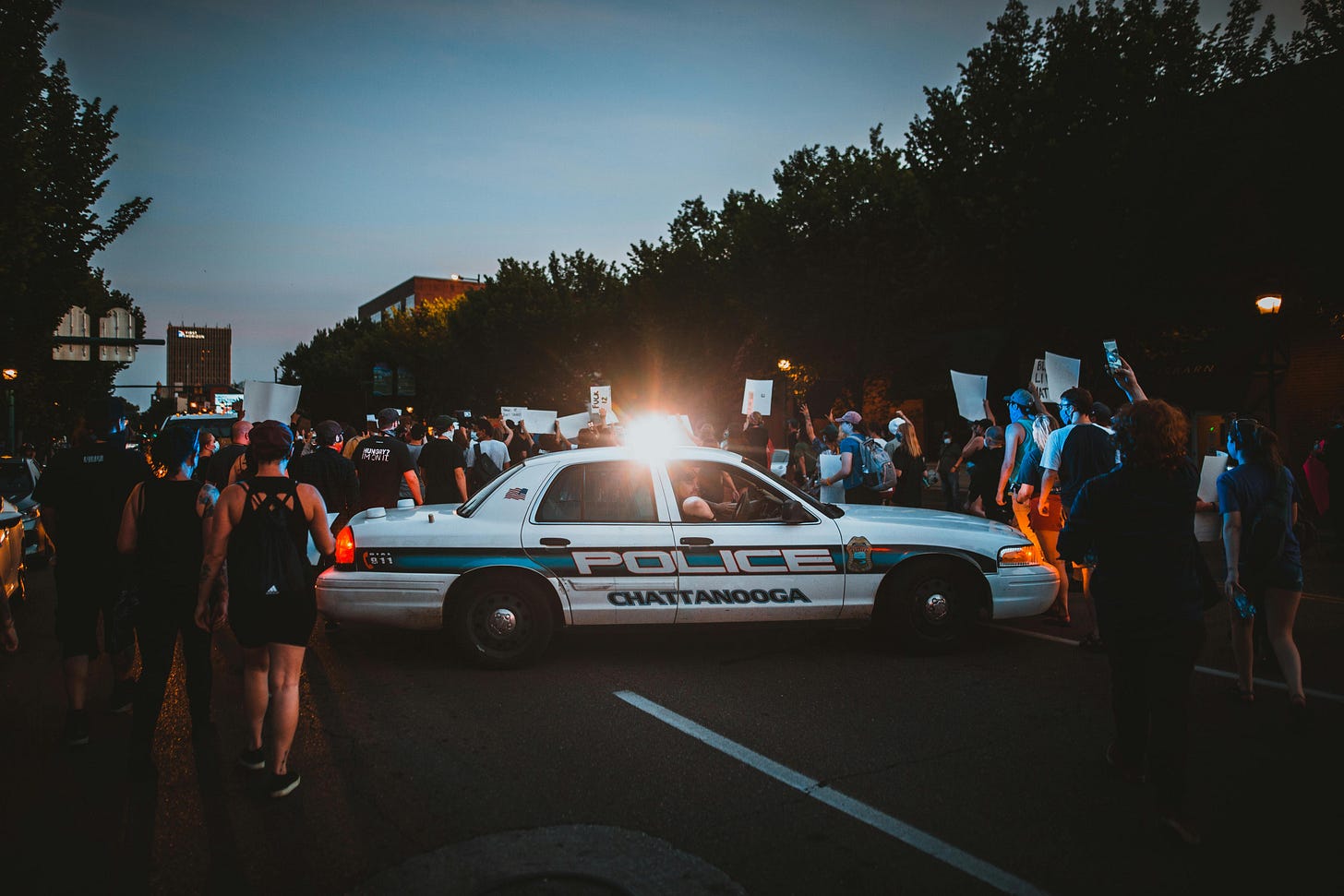 Crowd of protesters holding signs in a city street Crowd of protesters holding signs in a city street