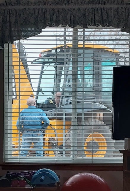 A person standing next to a yellow tractor

AI-generated content may be incorrect.