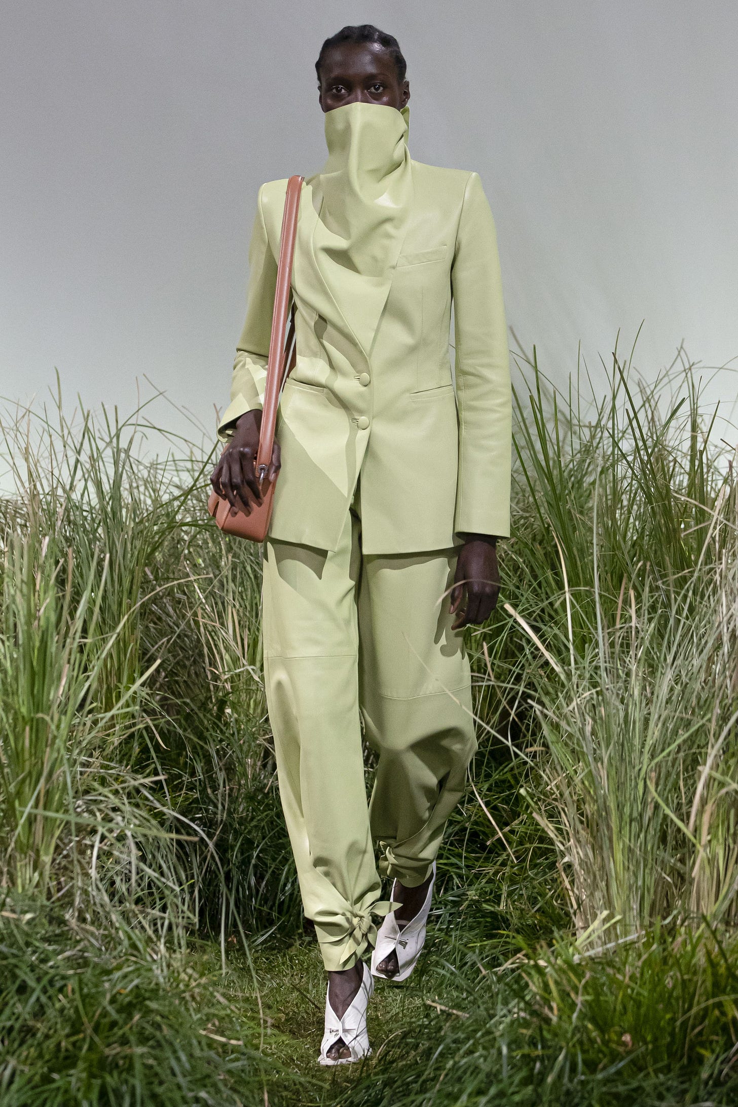 Image may contain Clothing Apparel Coat Shoe Footwear Plant Grass Human Person Suit and Overcoat