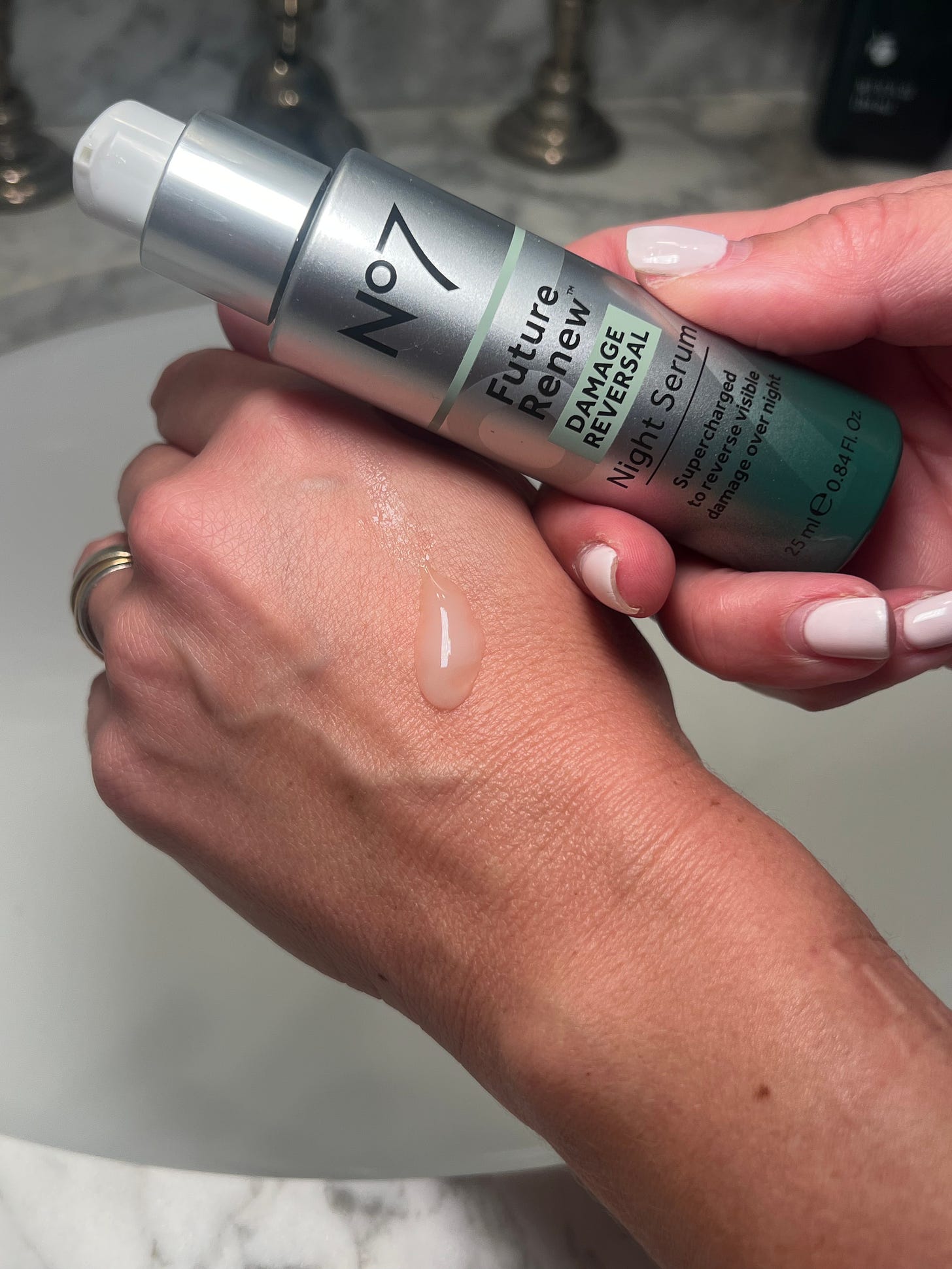 No7 Pure Retinol 0.3% Night Concentrate swatched on the back of Beauty Editor Donna Francis' hand with the bottle by the side for The Beauty Ed® substack