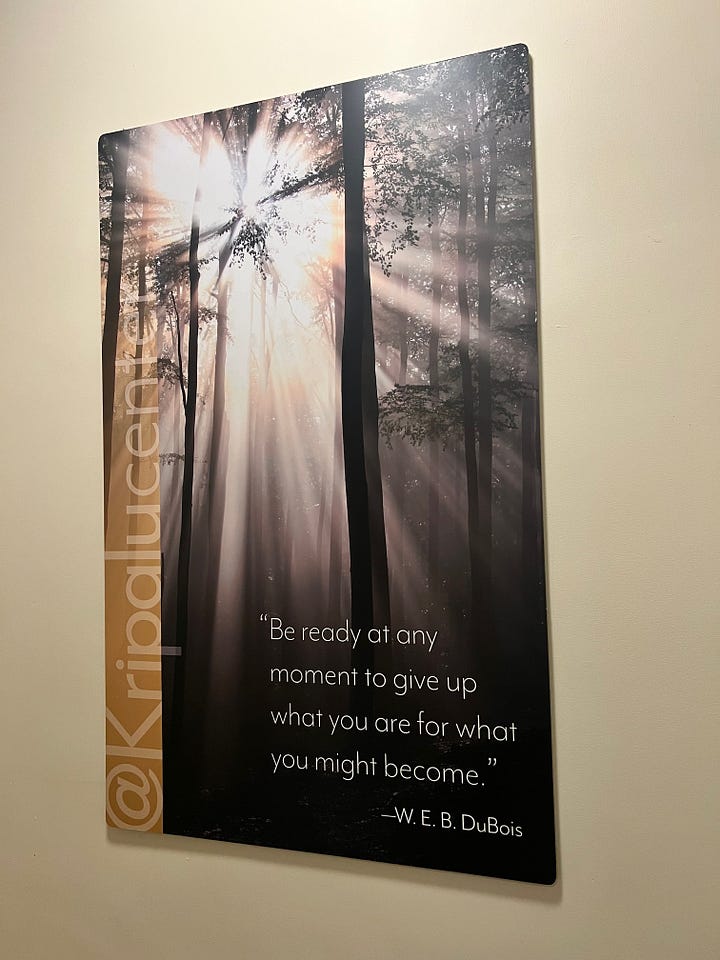 Kripalu's entrance, the lobby, a selfie of Kelsey in the elevator with the campus map, the sign to the healing arts waiting room, and a quote by W.E.B DuBois on the wall of the stairwell stating "Be ready at any moment to give up what you ae for what you might become."