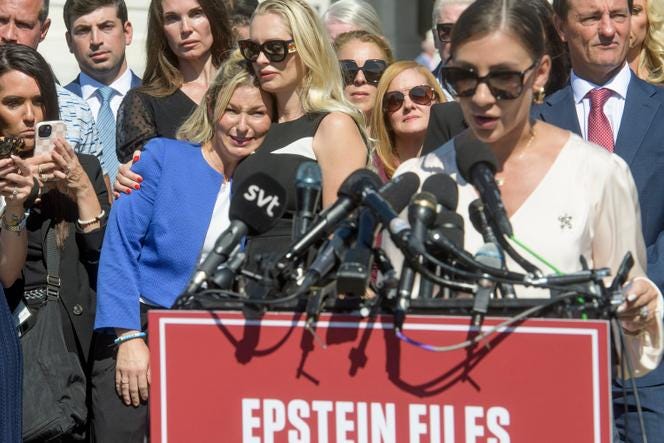 From left to right: Danielle Bensky embracing Anouska De Georgiou, and Marina Lacerda (at the microphone), all victims of Jeffrey Epstein, during a press conference outside the Capitol in Washington, on September 3, 2025.