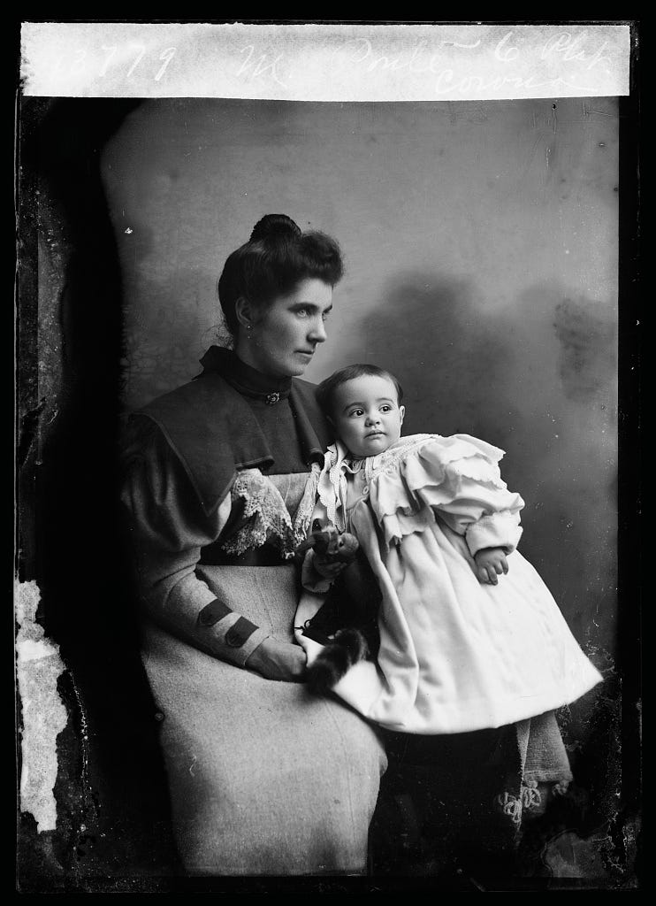 black and white photo of a woman with a toddler on her lap