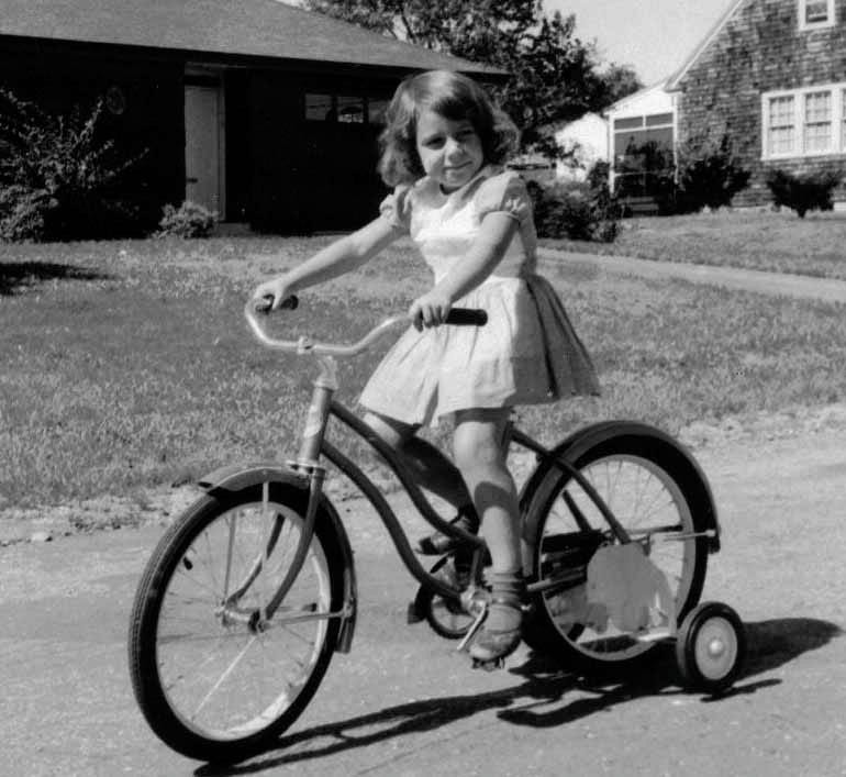 Kid biking with training wheels Kid biking with training wheels