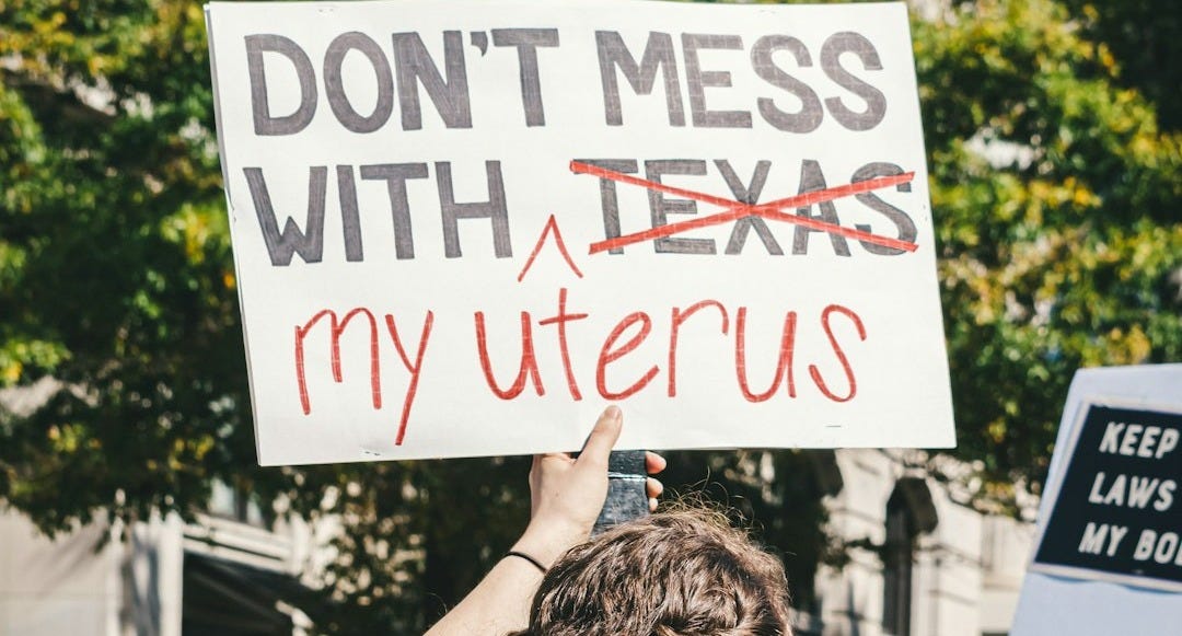 a woman holding a sign that says don't mess with texas my uter a woman holding a sign that says don't mess with texas my uter