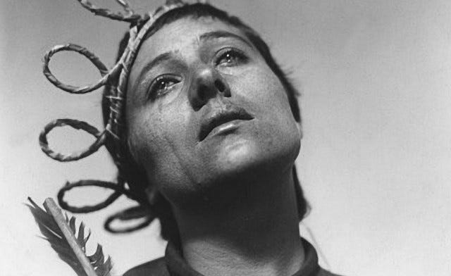 This may contain: an old photo of a woman with scissors on her head and hair in the air