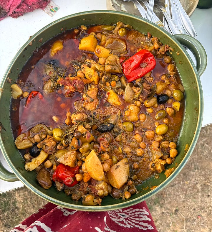 Four photographs: A woman in a colorful dress stands above a cylindrical oven with rounds of bread clutching the sides; a photograph of cooking urns beside small pits used for cooking; a photograph of a tree with large woven mats beneath it, set with plates; a green serving dish filled with a hearty stew with chickpeas and olives.