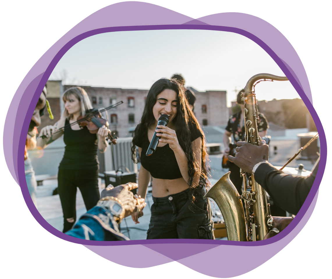 A woman, center, sings in a band including saxophone and violin.