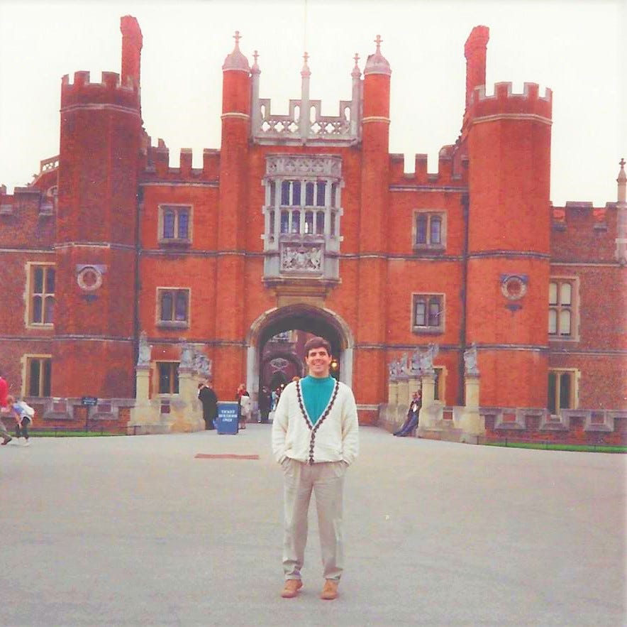 20-something man stand triumphantly in front of the real Hampton Court Palace 20-something man stand triumphantly in front of the real Hampton Court Palace