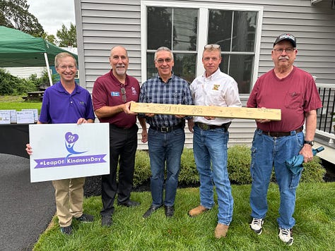 Pictures of a rebuilt house and the people who came by for the grand opening.