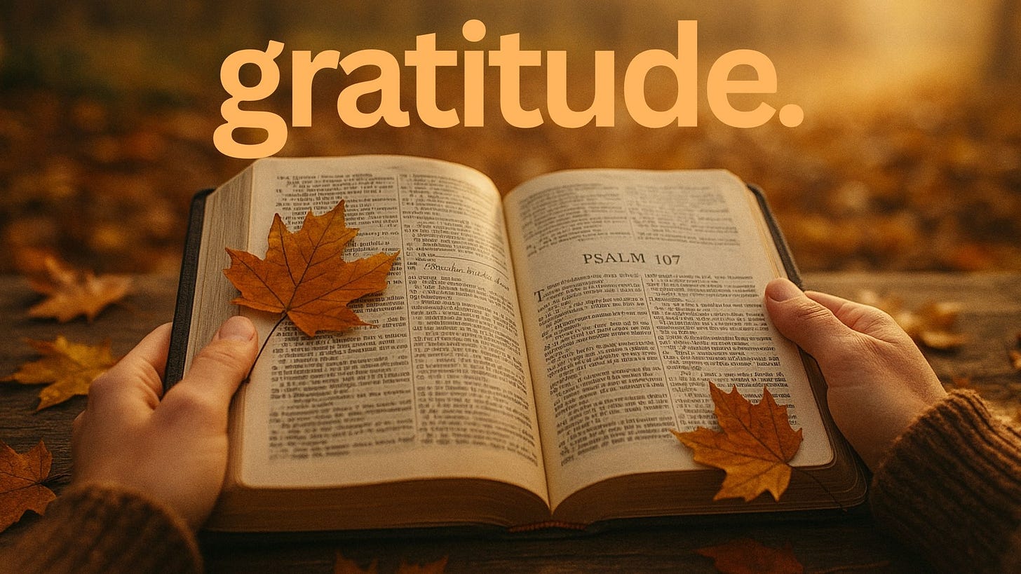 A pair of hands holds an open Bible turned to Psalm 107 on a wooden table covered with autumn leaves, with warm golden light glowing through the trees in the background.